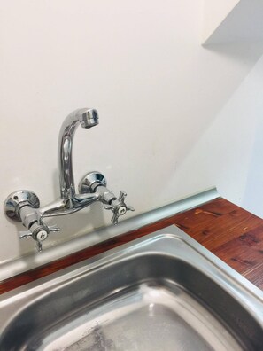 A stainless steel kitchen sink with a chrome faucet. - Apartment near Parliament (Tbilisi)