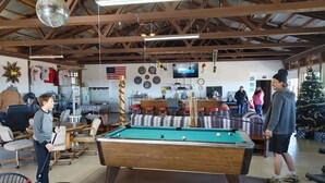 A billiards room with a pool table, chairs, and a Christmas tree. - Desert Oasis Campground (McNeal)