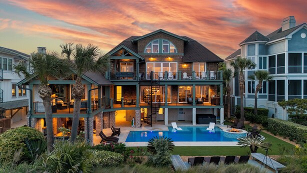A two-story house with a pool, outdoor seating, and a large balcony. - 95 Dune Lane -Oceanfront | Island Oasis | Booking now for 2027! (Hilton Head Island)