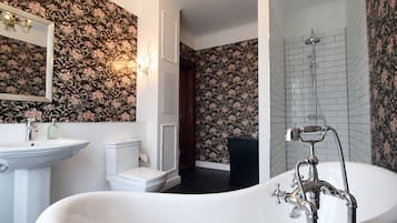 Bathtub, hair dryer, towels, toilet paper