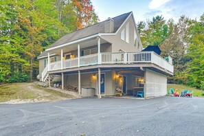 Una casa a due piani con veranda e garage.