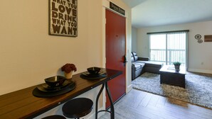 A kitchen with a wooden countertop, a red door, and a sign above it. - Abi's Place, No Stairs! Central Location!  Stylish!  3 BDRM 2 BA, Pool Available (Branson)