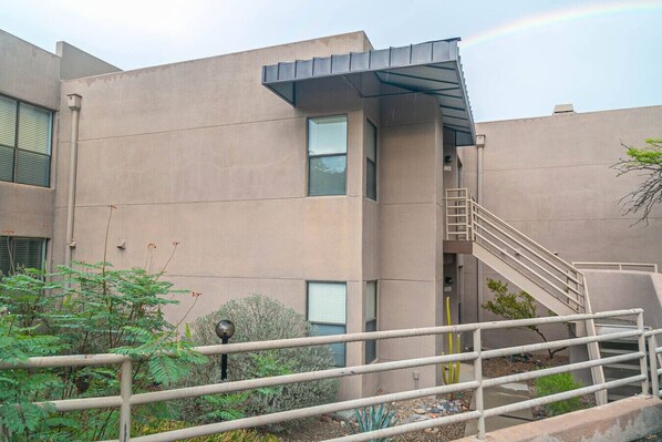 A modern building with a flat facade, a metal staircase, and a metal railing. - La Casa at Canyon View -Ventana (Tucson)