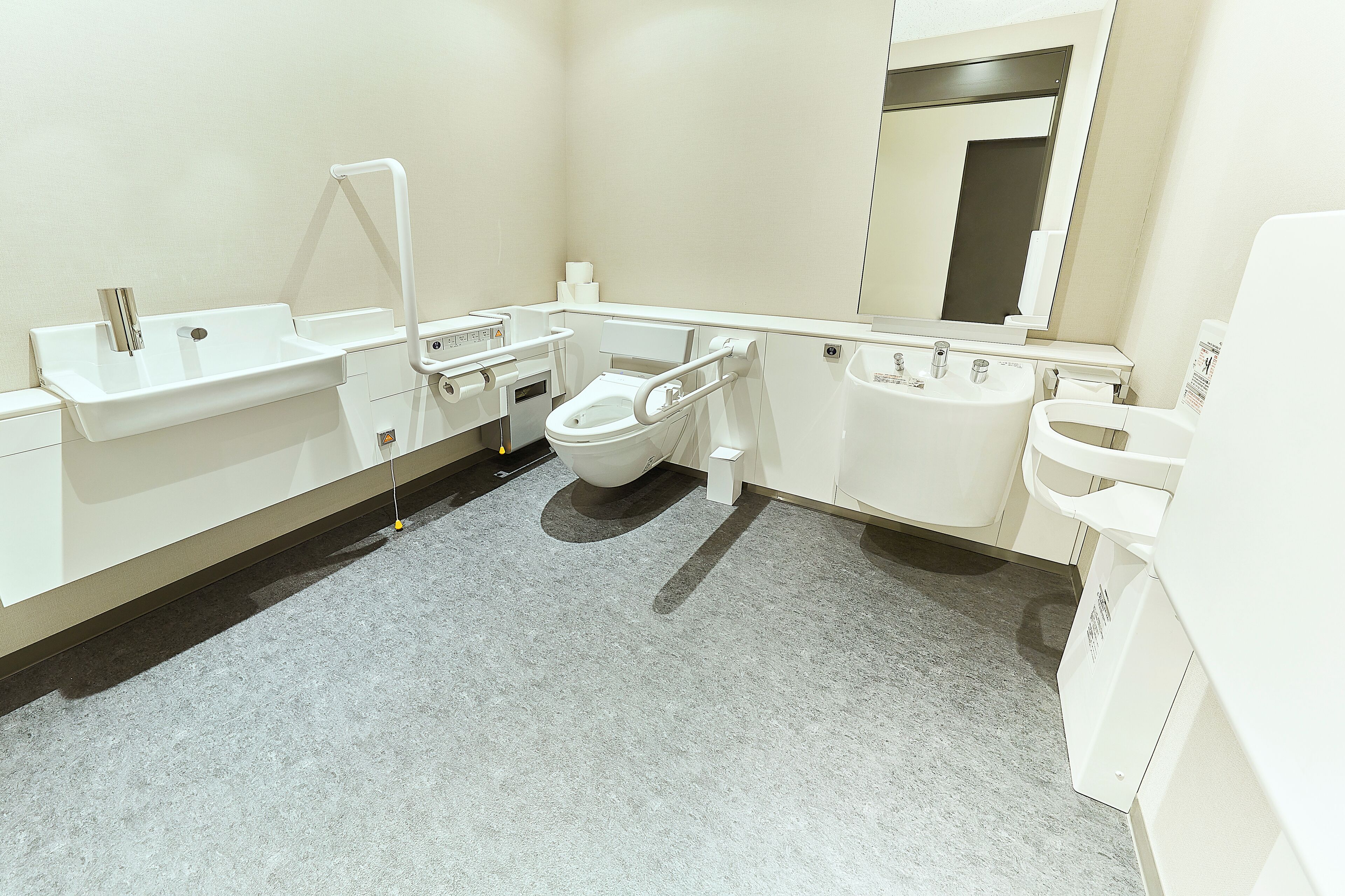 A modern bathroom with a toilet, sink, and bathtub.