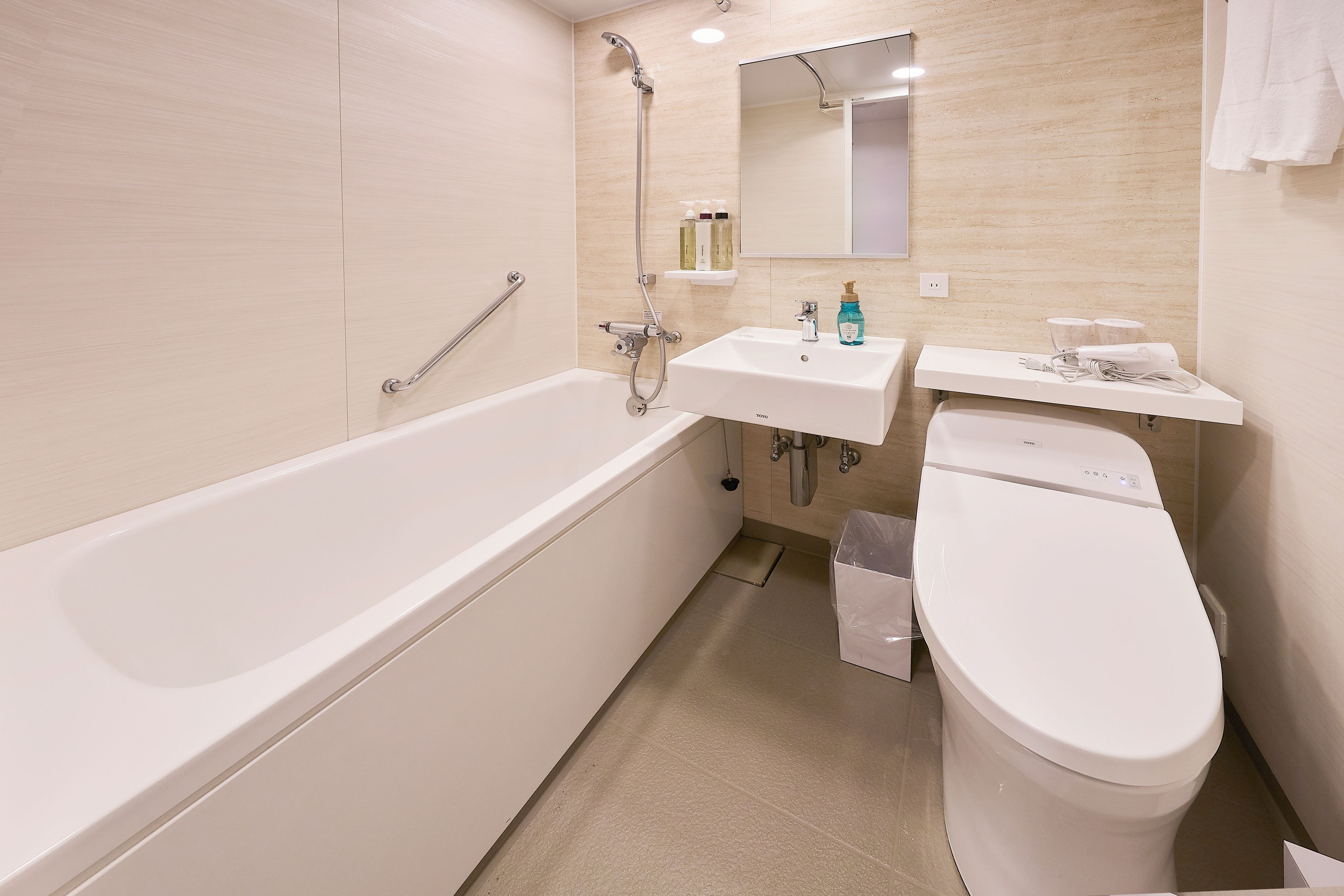 A modern bathroom with a bathtub, a sink, and a toilet.