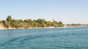 A coastal view with a large house on a cliff overlooking the sea. - SeaFront Stone Villa with private access to the Beach (Άγιος Σώστης)