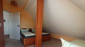 A bedroom with a loft bed, a door leading to another room, and a small window. - Whg. 3 - Holiday apartment in Seebad Bansin on the island of Usedom Baltic Sea (Heringsdorf)