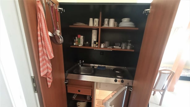 A compact kitchen with a sink, stove, and storage shelves. - Whg. 3 - Holiday apartment in Seebad Bansin on the island of Usedom Baltic Sea (Heringsdorf)