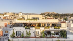 A modern building with multiple balconies, large windows, and outdoor seating areas. - L'Avventura Athens (Athens)
