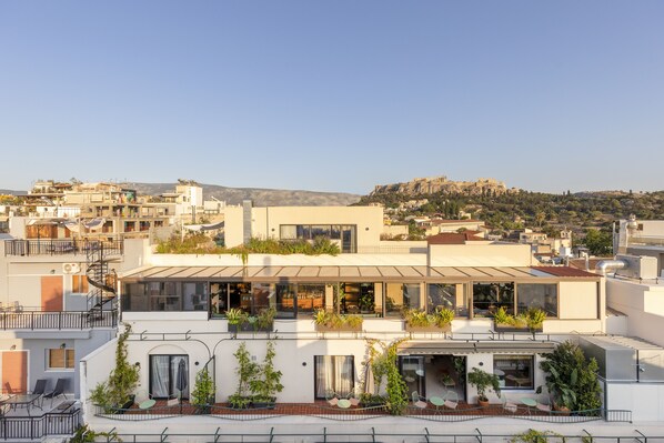 A modern building with multiple balconies, large windows, and outdoor seating areas. - L'Avventura Athens (Athens)