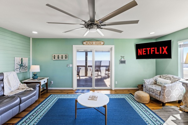 A 55" Roku TV, a large ceiling fan, and plenty of natural light to enjoy both entertainment and the scenery.