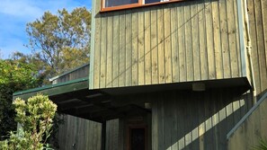 Un bâtiment en bois avec un toit végétalisé et une porte bien visible portant l’inscription « Dachboden ».