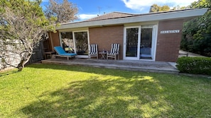 A two-story house with a covered patio, a brick exterior, and a sign reading "DALMENY". - Dune Retreat - Point Lonsdale (POINT LONSDALE)