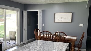 A kitchen with a granite countertop, wooden chairs, and a dining table. - Norris Lake-Ride Royal Blue-Tackett Creek (Jacksboro)