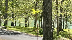 A tree-lined street with a mailbox and a lamp post. - Norris Lake-Ride Royal Blue-Tackett Creek (Jacksboro)