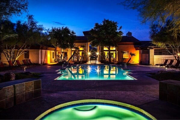 Relax by the serene pool surrounded by lush gardens and lounge chairs.