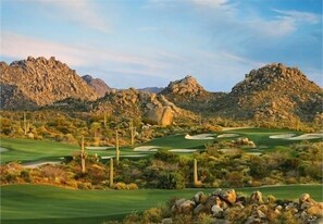 Play amidst the rugged desert landscape on this well-maintained golf course, surrounded by cacti and shrubs.