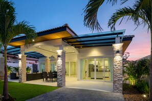 Vista frontal de la propiedad por la tarde o noche