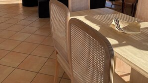 A living room with a sofa, chairs, a TV, and a table.