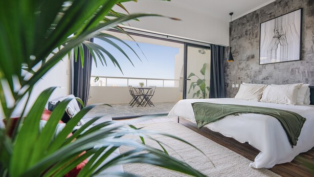 A bedroom with a bed, a balcony, and a view of the city. - Charming Flat With Amazing sea Line View (Cascais)