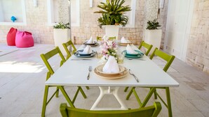 A dining table set with plates, glasses, and a centerpiece.