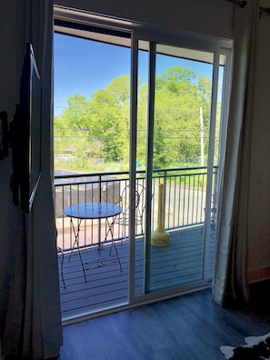 Enjoy the serene view from your balcony with a round table and two chairs.