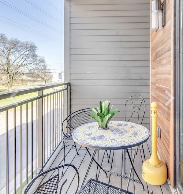 Enjoy a peaceful retreat on your balcony with a round table and two chairs.