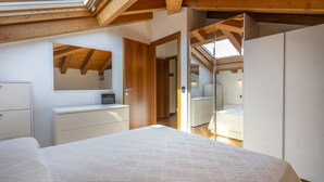 A bedroom with a large bed, a dresser, a mirror, and a wardrobe. - New Deal - APT with Terrace & Jacuzzi (Palmanova)