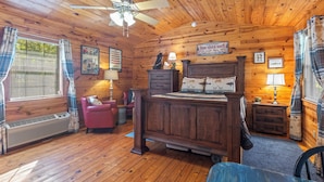 A wooden cabin bedroom with a bed, dresser, and a chair. - The Luxury Angler Cabin near the Buffalo/Couple's Retreat (Harriet)