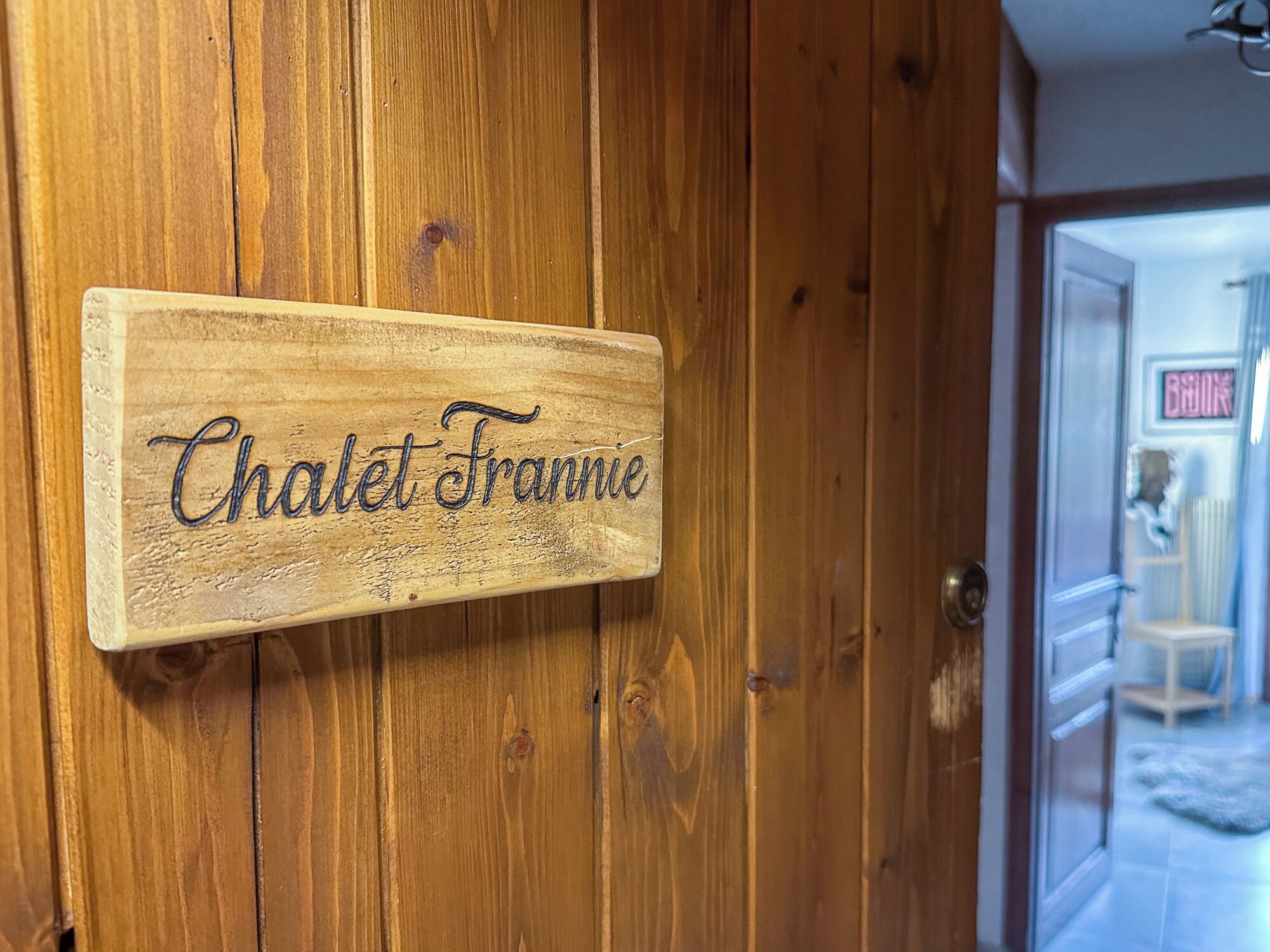 A wooden door with a sign that reads "Chalet Franne."