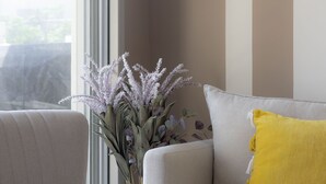 A modern living room with a sofa, armchair, and a small yellow table. - HighQuality TelAviv Apartment in theCity (Tel Aviv)