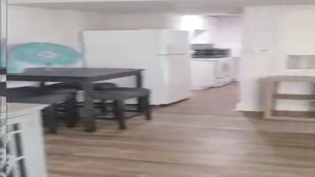 A kitchen with white appliances, a dining table with chairs, and a wooden floor. - Lovely 2 bedroom apartment all to yourself (houston)