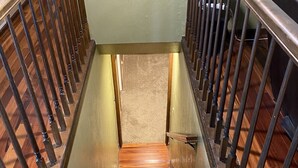 A wooden staircase with metal railings leading to a landing. - Spacious 5 bedroom house minutes from Red Rocks (Littleton)