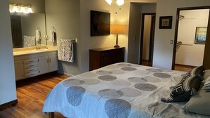 A bedroom with a bed, a dresser, a vanity with a mirror, and a ceiling fan. - Spacious 5 bedroom house minutes from Red Rocks (Littleton)