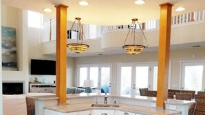 A spacious kitchen with granite countertops, white cabinetry, and pendant lighting. - Luxury Oceanside Pool Home Boasting Incredible Views - Large 5/3 w/Heated Pool (St. Augustine)