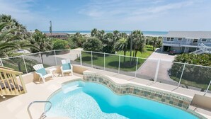 A swimming pool with a view of the ocean and palm trees. - Luxury Oceanside Pool Home Boasting Incredible Views - Large 5/3 w/Heated Pool (St. Augustine)