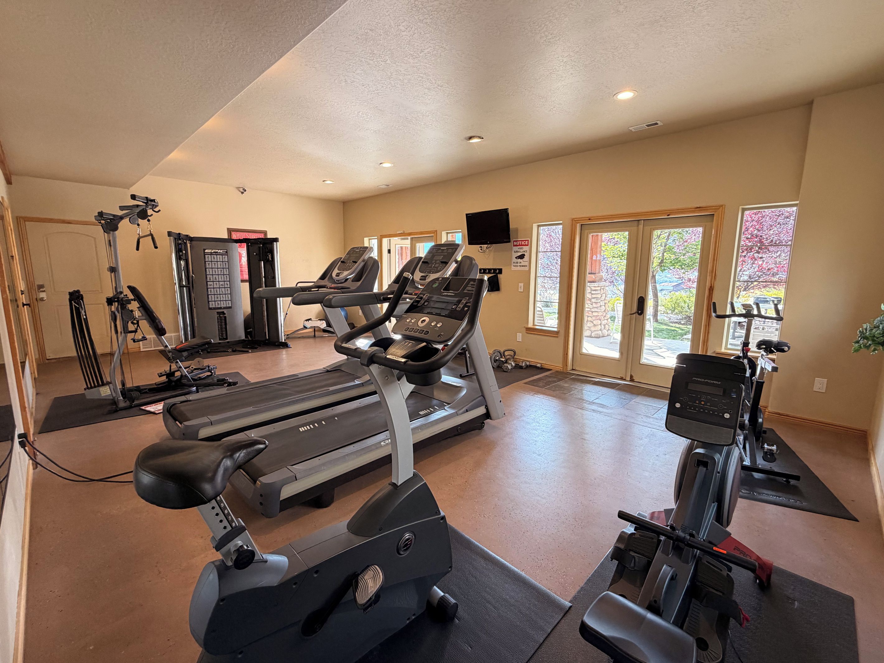 A gym with treadmills, elliptical machines, and weight equipment.