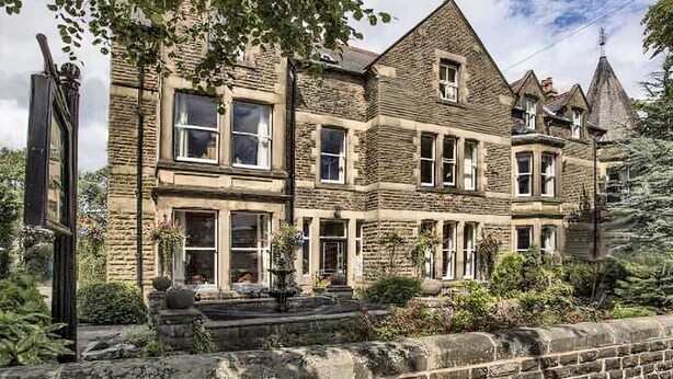A historic stone building with multiple windows and a prominent tower. - Kingscroft (Buxton)