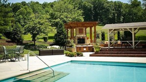 A pool area with a pergola, outdoor seating, and a barbecue area. - Beautiful New Cottage w/ Endless Hilltop Views (Paoli)
