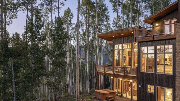 A wooden cabin with a balcony, large windows, and a hot tub in the yard. - Canyon View Retreat - Scenic & Secluded (Telluride)