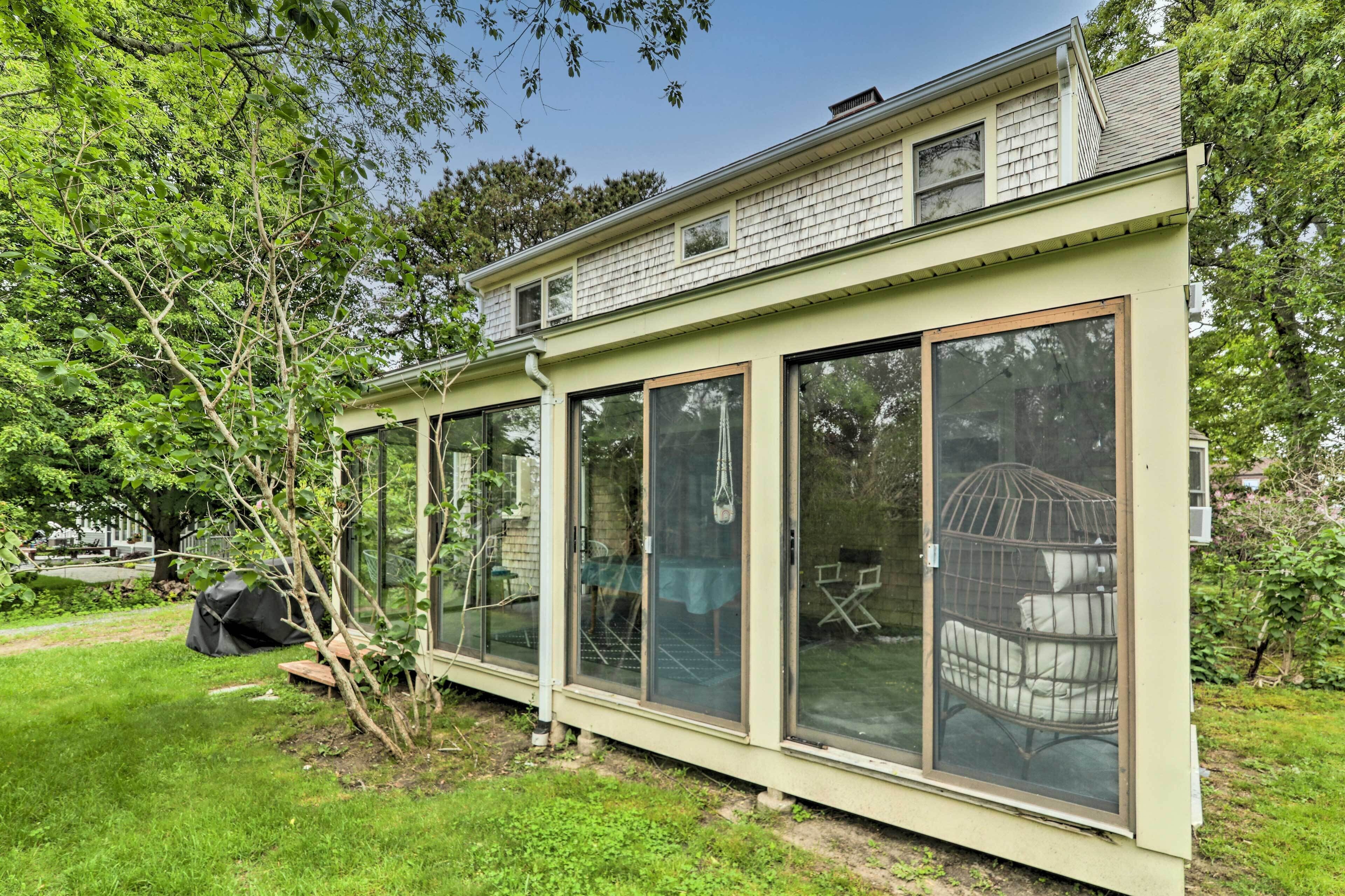 A house with large glass windows and a covered porch.