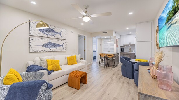 A modern living room with a sofa, coffee table, and artwork on the wall. - 1 Block to Beach, heart of Old Naples, newly renovated, perfect location (Naples)
