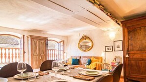 A dining area with a long table set for a meal, wooden chairs, and a large mirror on the wall. - Vacation home La Roq by Interhome (Roquebrune sur Argens)