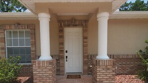 A house with a brick facade, a white door, and a covered porch with columns. - Beautiful 2Bed,2Bath,2Car Garage Stunning Cul-de-sac property on 2 acres Estate (Spring Hill)