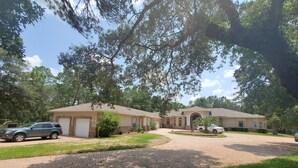 A two-story house with a driveway, garage, and a well-maintained lawn. - Beautiful 2Bed,2Bath,2Car Garage Stunning Cul-de-sac property on 2 acres Estate (Spring Hill)