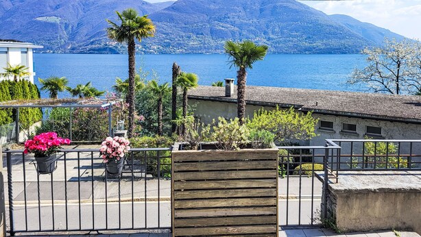 A balcony with a view of a lake and mountains. - Casa Stella App. 1 by Interhome (Brissago)