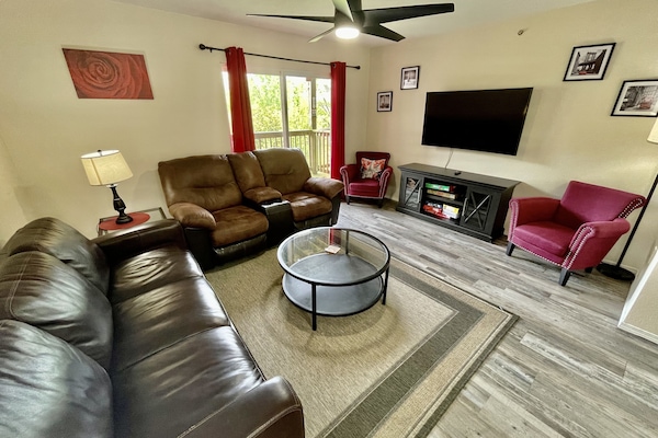 Family room with sleeper sofa and loveseat and 55" smart TV