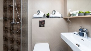 A modern bathroom with a shower, toilet, and sink. - Apartment Kantun (Dubrovnik)