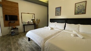 A hotel room with a large bed, a desk, a television mounted on the wall, and two framed artworks. - Floating Sanctuary Resort Bulacan powered by Cocotel (Santa Maria)