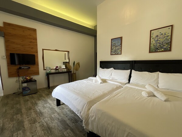 A hotel room with a large bed, a desk, a television mounted on the wall, and two framed artworks. - Floating Sanctuary Resort Bulacan powered by Cocotel (Santa Maria)